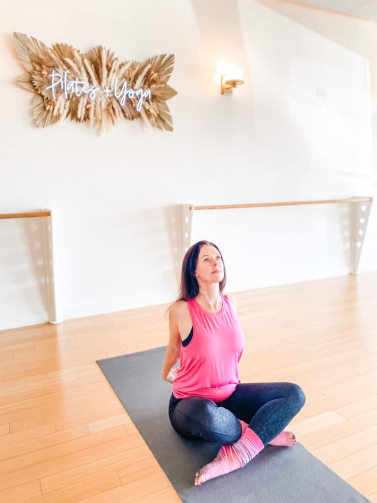 Breast Cancer survivor practicing Pilates chest expansion