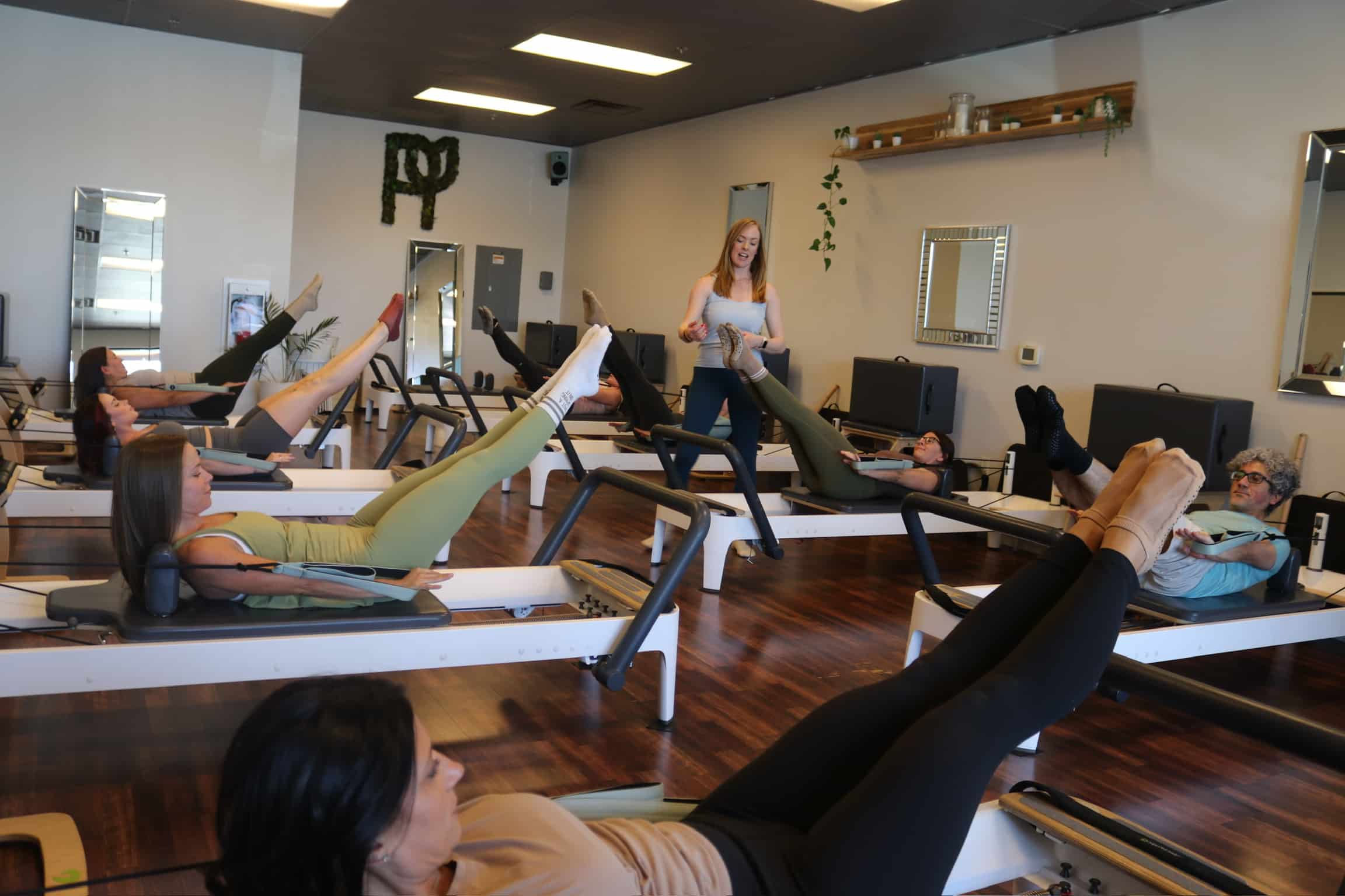 Pilates group class. Students performing Arm series.